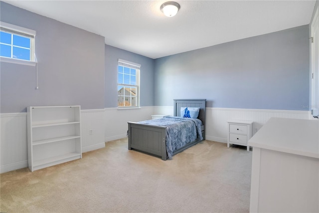 bedroom featuring light colored carpet