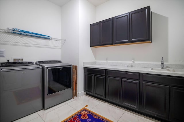 laundry room featuring washer and dryer, cabinets, and sink