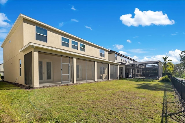 rear view of house featuring a yard