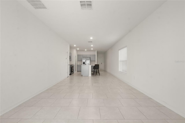 hallway featuring light tile patterned flooring