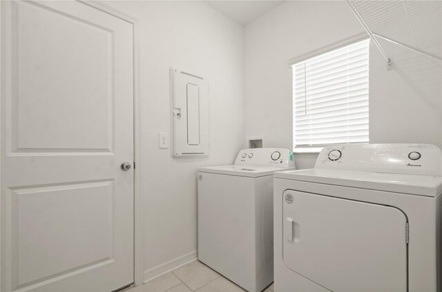 laundry area featuring light tile patterned flooring, electric panel, and independent washer and dryer