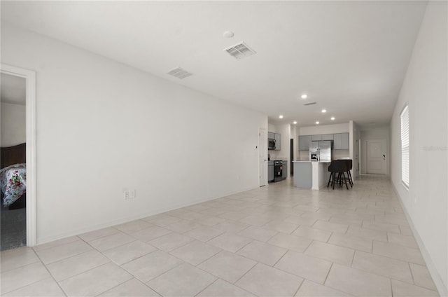 unfurnished living room with light tile patterned floors