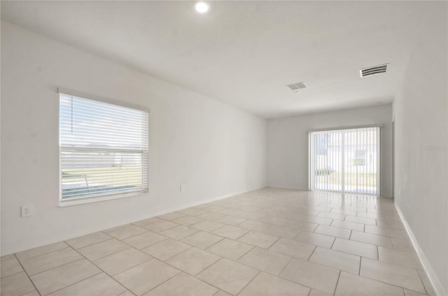 spare room with light tile patterned floors