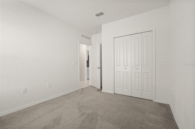 unfurnished bedroom with carpet flooring and a closet