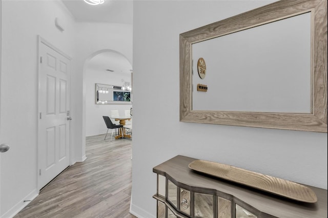 corridor with light hardwood / wood-style flooring