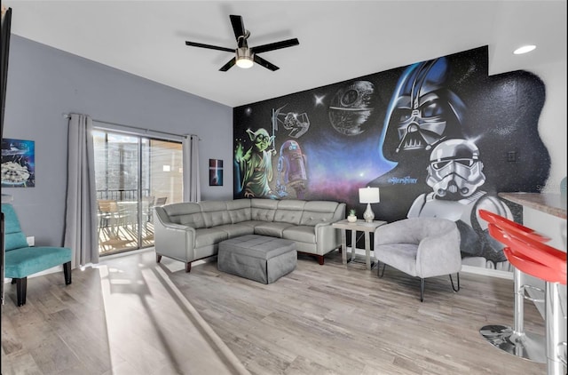 living room featuring hardwood / wood-style flooring and ceiling fan