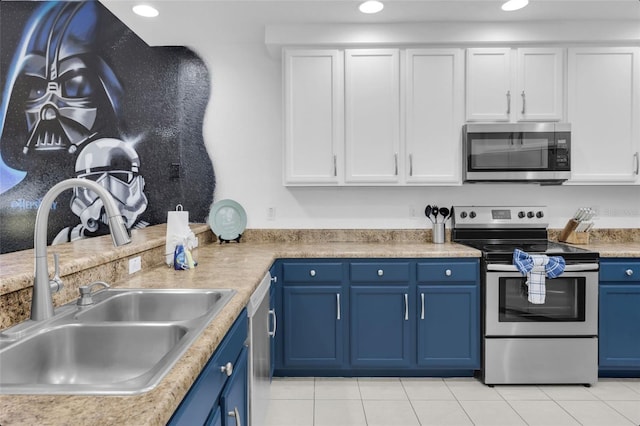 kitchen featuring blue cabinetry, white cabinetry, sink, and appliances with stainless steel finishes