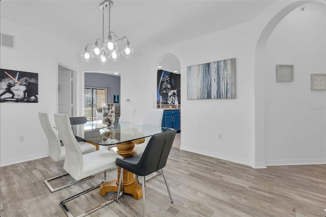 dining space featuring a chandelier and light hardwood / wood-style floors