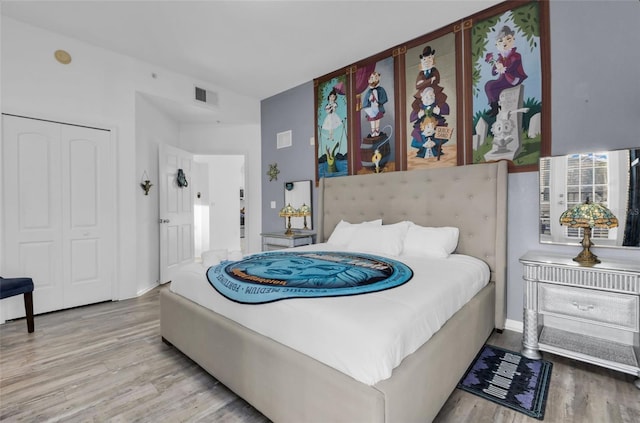 bedroom featuring light hardwood / wood-style flooring and a closet