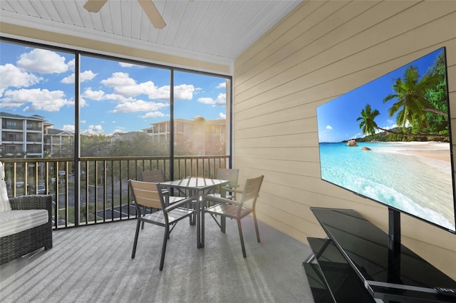 unfurnished sunroom with ceiling fan