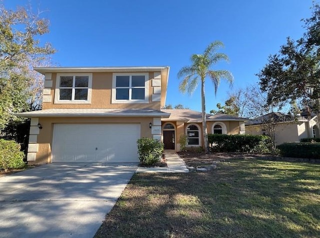 view of front of property with a garage and a front yard