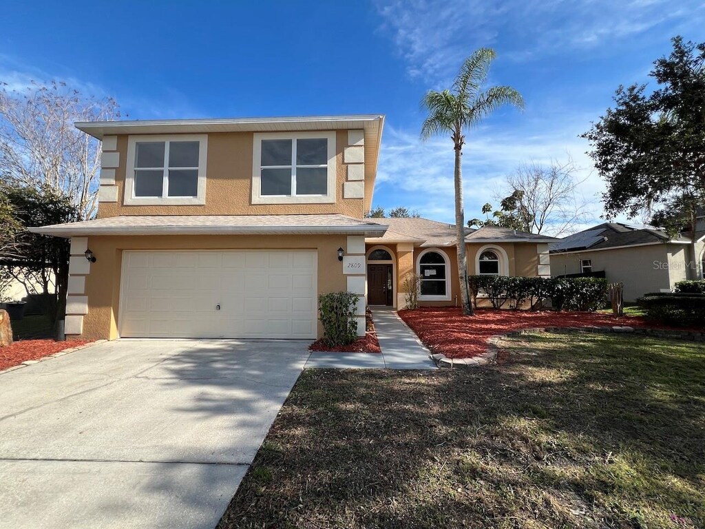 view of front of house with a garage and a front yard