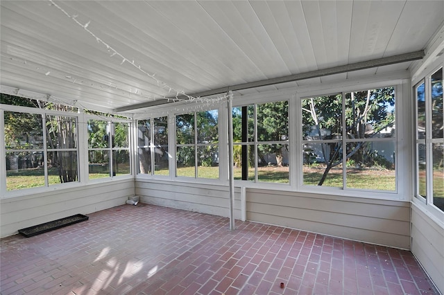 unfurnished sunroom featuring wood ceiling