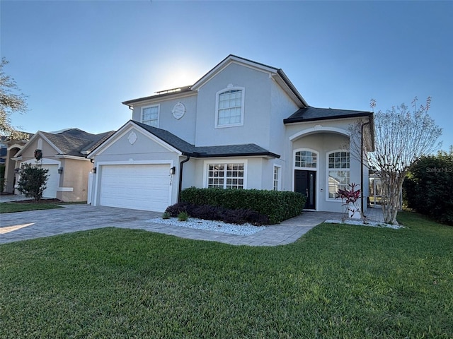 view of front property with a front yard and a garage