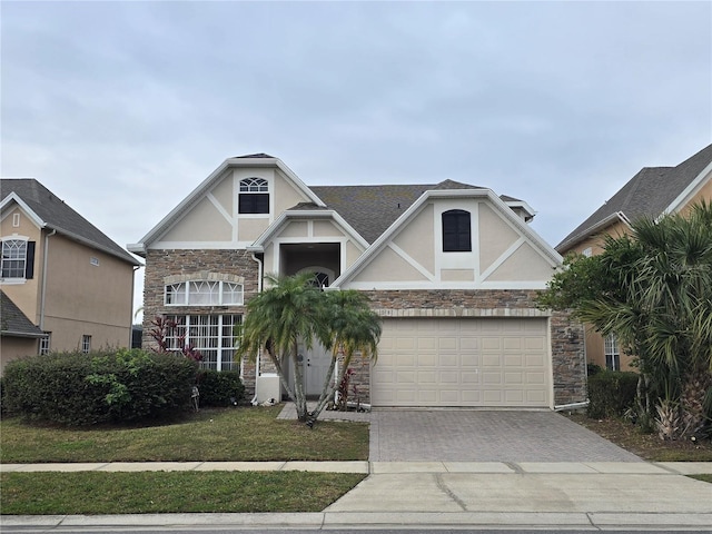 view of front of property featuring a front lawn and a garage