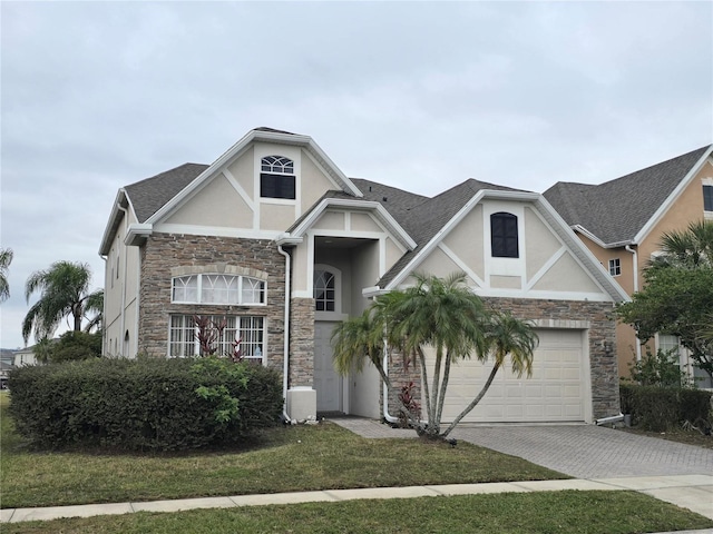 view of front of property featuring a front yard and a garage