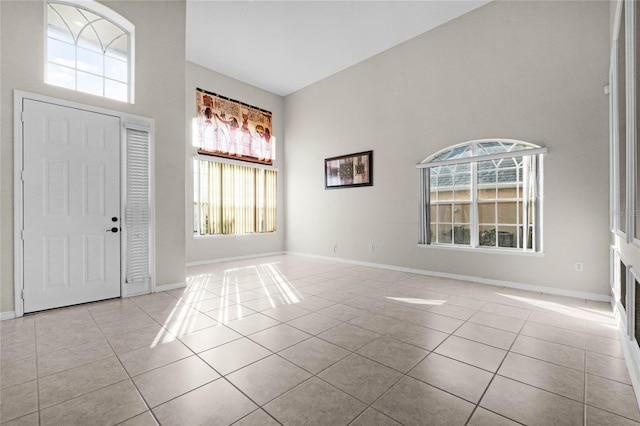 tiled entrance foyer with a wealth of natural light and a high ceiling