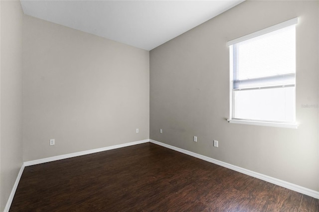 spare room with dark hardwood / wood-style floors