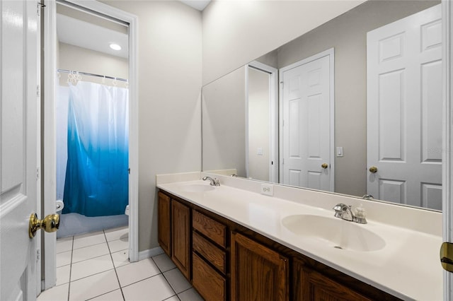 bathroom featuring tile patterned flooring, vanity, and walk in shower