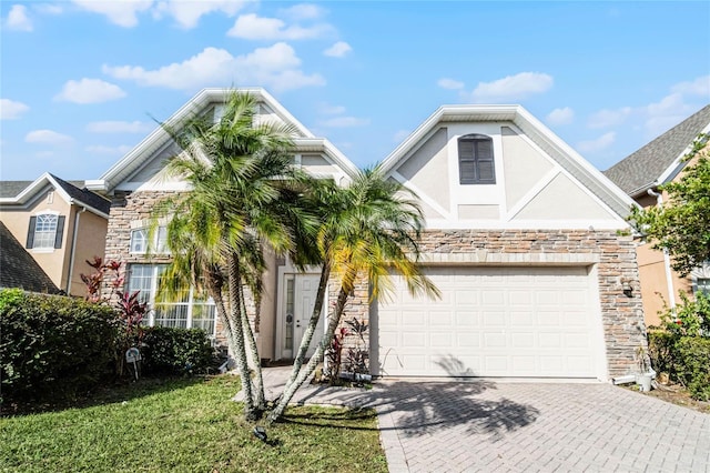 1108 Darnaby Way, Orlando, FL 32824 - view of front facade featuring a garage, stucco siding, driveway, and stone siding