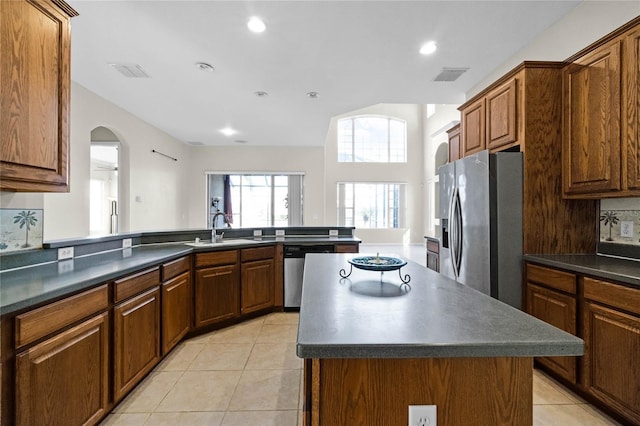 1108 Darnaby Way, Orlando, FL 32824 - kitchen with visible vents, dark countertops, a sink, light tile patterned floors, and stainless steel appliances