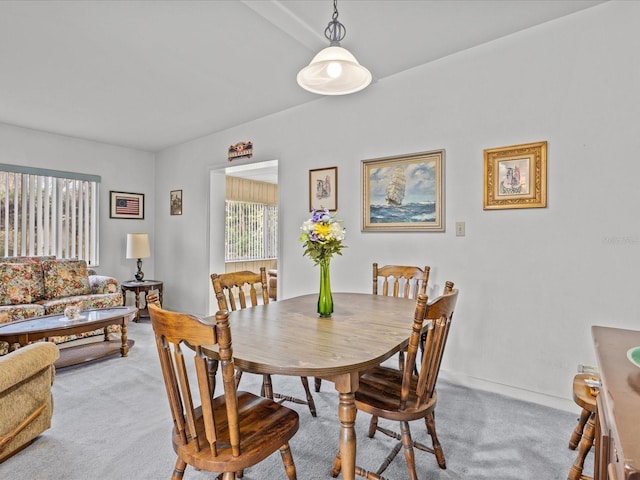 dining space featuring light carpet