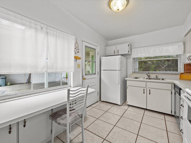 kitchen featuring range, white cabinetry, white refrigerator, light tile patterned flooring, and sink