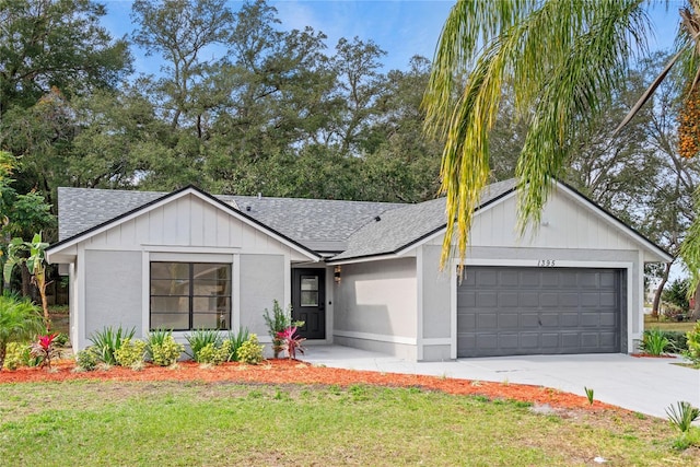 view of front of home featuring a garage and a front yard