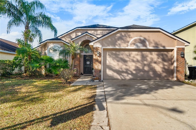 ranch-style house with a garage and a front lawn