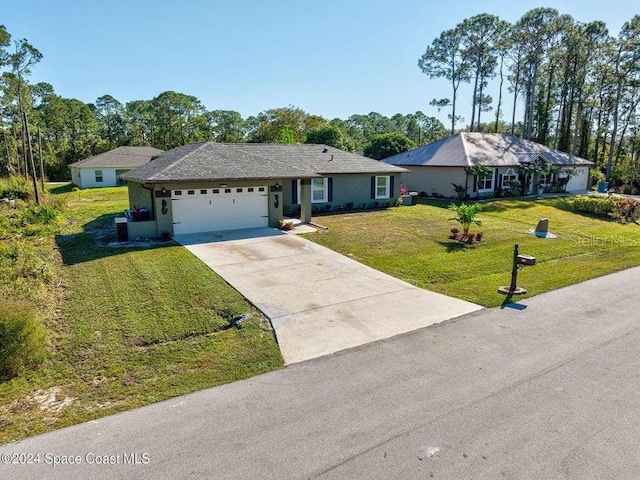 ranch-style house featuring a garage, concrete driveway, and a front yard