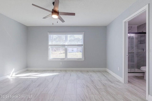 unfurnished bedroom featuring a ceiling fan, baseboards, and a textured ceiling