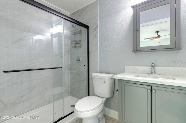 full bathroom with a textured wall, toilet, vanity, baseboards, and a stall shower