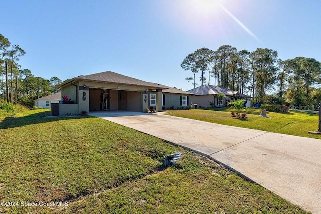 ranch-style home with a garage, a front lawn, and concrete driveway