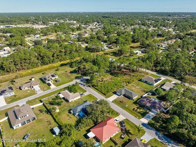 bird's eye view with a wooded view and a residential view