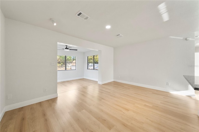 spare room with light hardwood / wood-style floors and ceiling fan