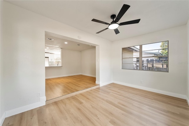 empty room featuring ceiling fan and light wood-type flooring