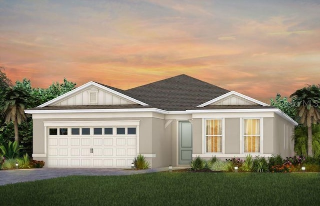 view of front facade featuring a lawn and a garage