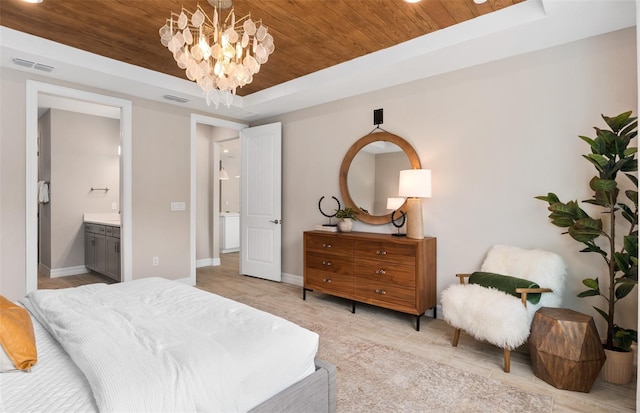 bedroom with a tray ceiling, ensuite bath, wooden ceiling, and a notable chandelier