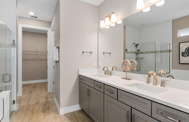 bathroom with vanity, an enclosed shower, and wood-type flooring