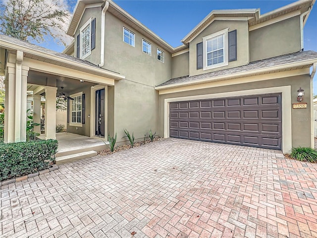 view of front of property with ceiling fan and a garage