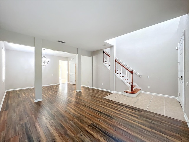 basement featuring dark hardwood / wood-style floors and a notable chandelier