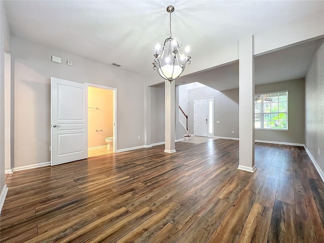 interior space featuring dark hardwood / wood-style floors and a notable chandelier