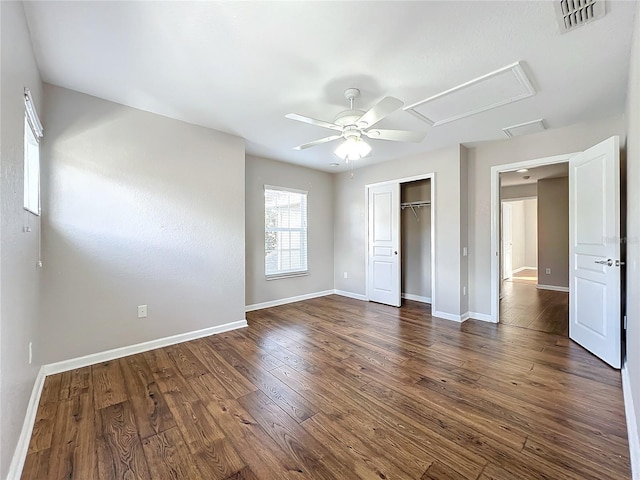 unfurnished bedroom with ceiling fan, a closet, and dark wood-type flooring