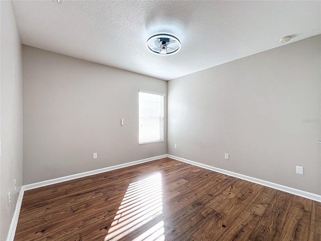 empty room featuring hardwood / wood-style floors and a textured ceiling