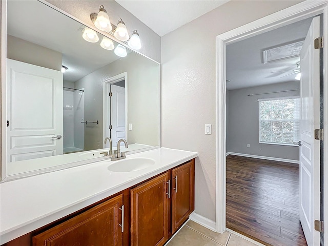 bathroom featuring vanity, tile patterned floors, and walk in shower