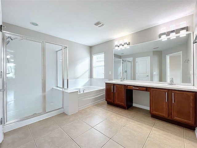 bathroom with tile patterned floors, vanity, and shower with separate bathtub