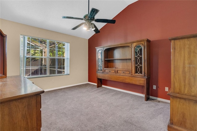 unfurnished living room featuring ceiling fan, carpet floors, and lofted ceiling