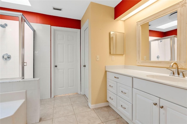 bathroom with tile patterned floors, vanity, and separate shower and tub