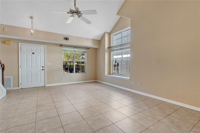 tiled foyer featuring a textured ceiling, vaulted ceiling, and ceiling fan