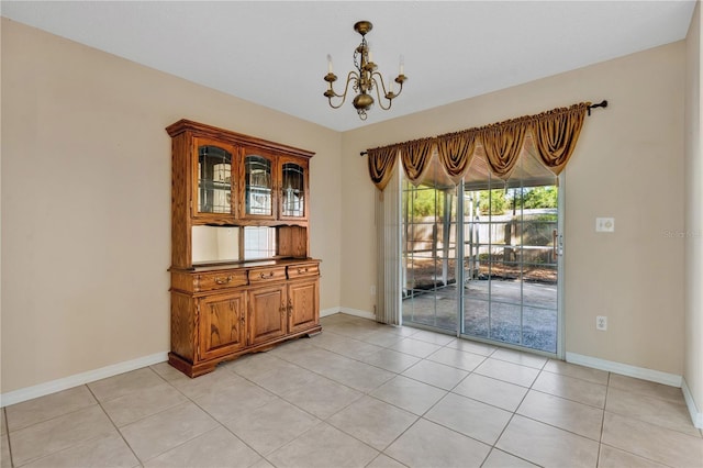 dining space featuring a notable chandelier and light tile patterned flooring